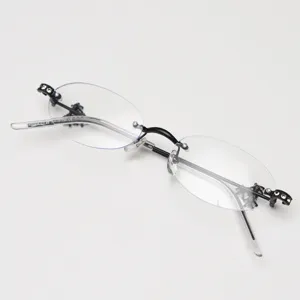 Fashion rimless oval eyeglasses frame for women with rhinestone decor and clear lenses.