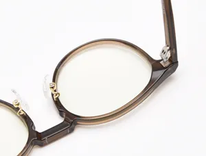 Detailed view of the retro round optical glasses frame, highlighting the hinge and nose pads.