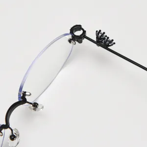 Detailed close-up of a stylish rimless oval eyeglasses frame with sparkling rhinestones.
