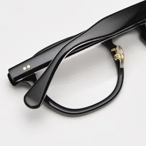 Detailed close-up view of black acetate optical glasses frame with retro thick rim design.