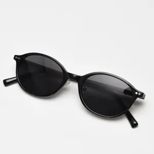 Classic black oval TR90 polarized sunglasses, vintage minimalist style, detailed close-up shot.