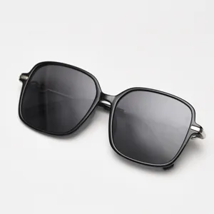 Close-up of stylish large square polarized sunglasses with black frames and metal accents.