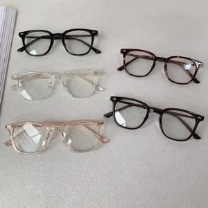 Detail shot showing multiple colors of TR90 glasses frames laid out on a textured surface.