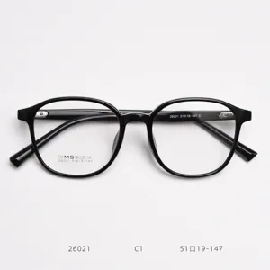 Detailed view of TR90 black optical eyeglass frames, classic round design, lightweight fit.