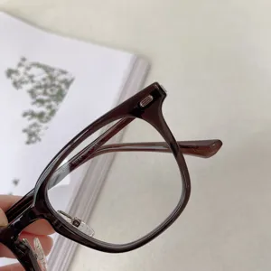 Close-up detail shot of the brown TR90 optical glasses frame, highlighting temple markings.