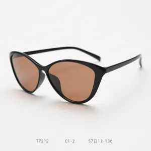 Cat-eye sunglasses detail view, black frame and brown lens, trendy eyewear for women style.