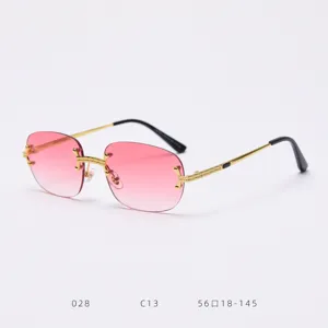 Detailed view of vintage style rimless gradient pink sunglasses with ornate gold metal frames.