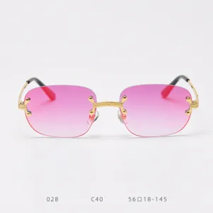 Detailed view of frameless sunglasses with pink gradient lenses and golden metal bridge.