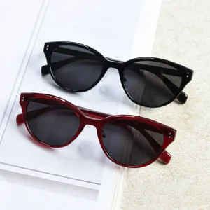 Close-up detail of stylish cat-eye polarized sunglasses in black and red trendy eyewear.