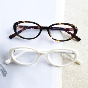 Close-up detail of retro small oval eyeglasses frames in tortoiseshell and white, trendy style.