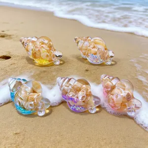 Macro detail view of colorful seashell quicksand keychain pendants on natural beach sand