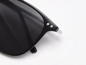 Detail shot of black square polarized sunglasses with metal rivets and frame specs.