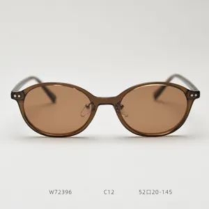 Detail view of stylish oval TR90 sunglasses with brown polarized lenses and frame.
