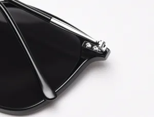 Detail shot of stylish square sunglasses frame hinge, premium polarized eyewear accessory.