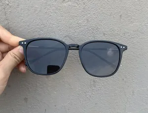 Detailed view of black square frame sunglasses, stylish oversized polarized eyewear.