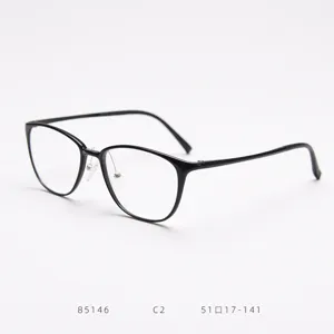 Close-up detail of lightweight optical glasses frame with clear lens and modern black rim.