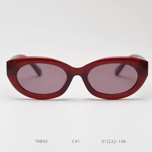 Detail shot of retro wine red oval cat-eye sunglasses with gradient lenses and chic frame.