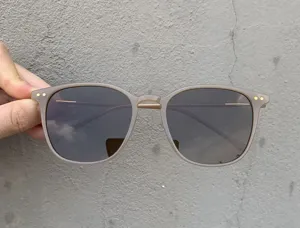 Detailed view of trendy square polarized sunglasses with grey frame and metallic details.