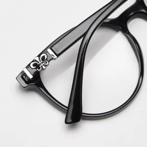 Black round optical eyeglass frame with stylish metal temple decoration for daily wear.