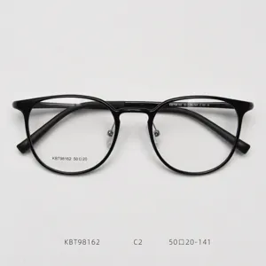 Close-up detail of the classic black round optical frame, showing bridge and temples.