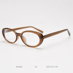 Detail view of vintage small oval eyeglasses frame in brown color, clear side structure.