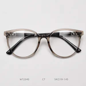 Large round eyeglass frame with vintage cross metal decor and gradient brown translucent rims.