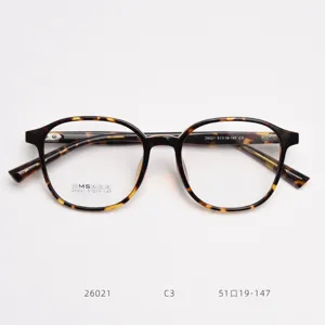 Detailed close-up of tortoiseshell optical glasses frame, featuring clear demonstration lenses and temples.