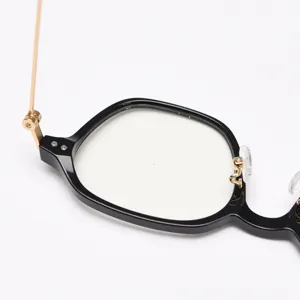 Close-up details of black frame and gold metal temples glasses, showing fine craftsmanship.
