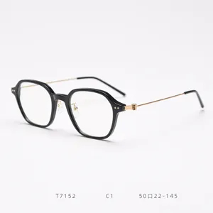 Detailed view of black polygonal eyeglass frames with slim metal temples and clear demo lenses.
