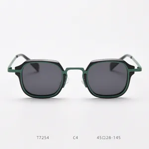 Detail view of retro small metal frame sunglasses with green black contrast and dark polarized lenses.