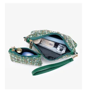 Detailed view of green tweed cosmetic bag set with zipper and wrist strap. High quality.
