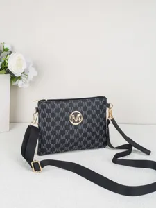 Close-up detail of stylish black crossbody bag with M monogram pattern and gold hardware.