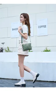 Green tweed crossbody bag for women, elegant Chanel-style shoulder bag with chain strap.