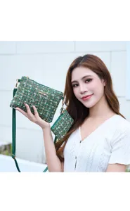 Green tweed crossbody bag detail shot, featuring elegant chain hardware and matching coin purse.