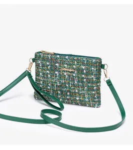 Green tweed crossbody cosmetic bag with gold hardware, elegant small fragrance style pouch.