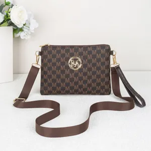 Brown monogram crossbody bag with envelope design, metal M logo, and adjustable shoulder strap.