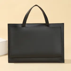 Detailed view of minimalist black laptop handbag, spacious design for daily business use.