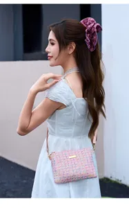 Chic pink tweed crossbody bag detailed shot, elegant daily fashion accessory with gold hardware.