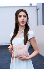 Pink tweed clutch bag detail, elegant woven wristlet purse for women daily chic fashion style.