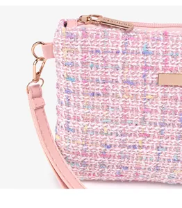 Close-up detail of pink tweed crossbody bag, showcasing woven fabric texture and hardware.