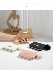 Detailed view of short women wallets featuring heart embossed pattern and soft pom-pom charm.