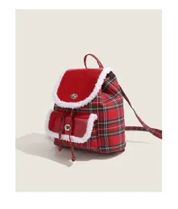 Red plaid backpack detail with fuzzy shearling trim, patent leather flap, and metal lock.