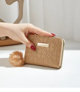 Women short zipper wallet with clover embossed pattern and cute plush pompom charm.
