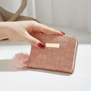 Women short pink wallet coin purse with cute clover heart pattern and fluffy pom pom charm.