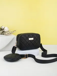 Black quilted crossbody camera bag with wide strap and round coin pouch, chic design.