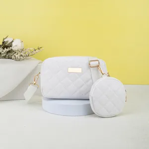 White quilted camera bag crossbody set with chic coin purse and gold tone hardware.