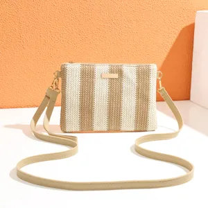 Detailed view of the woven striped crossbody bag featuring a chic textured surface and gold hardware.