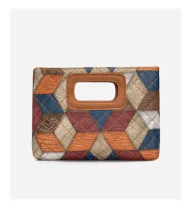 Detailed view of the ethnic style patchwork leather clutch bag with geometric pattern.