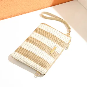 Striped woven wristlet clutch bag detail showing premium texture and golden hardware finish.