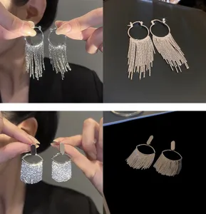 Detailed view of silver fringe tassel earrings and rhinestone geometric design, elegant.